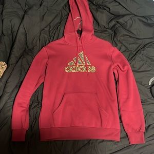 A garnet sweatshirt with a camo logo on it.